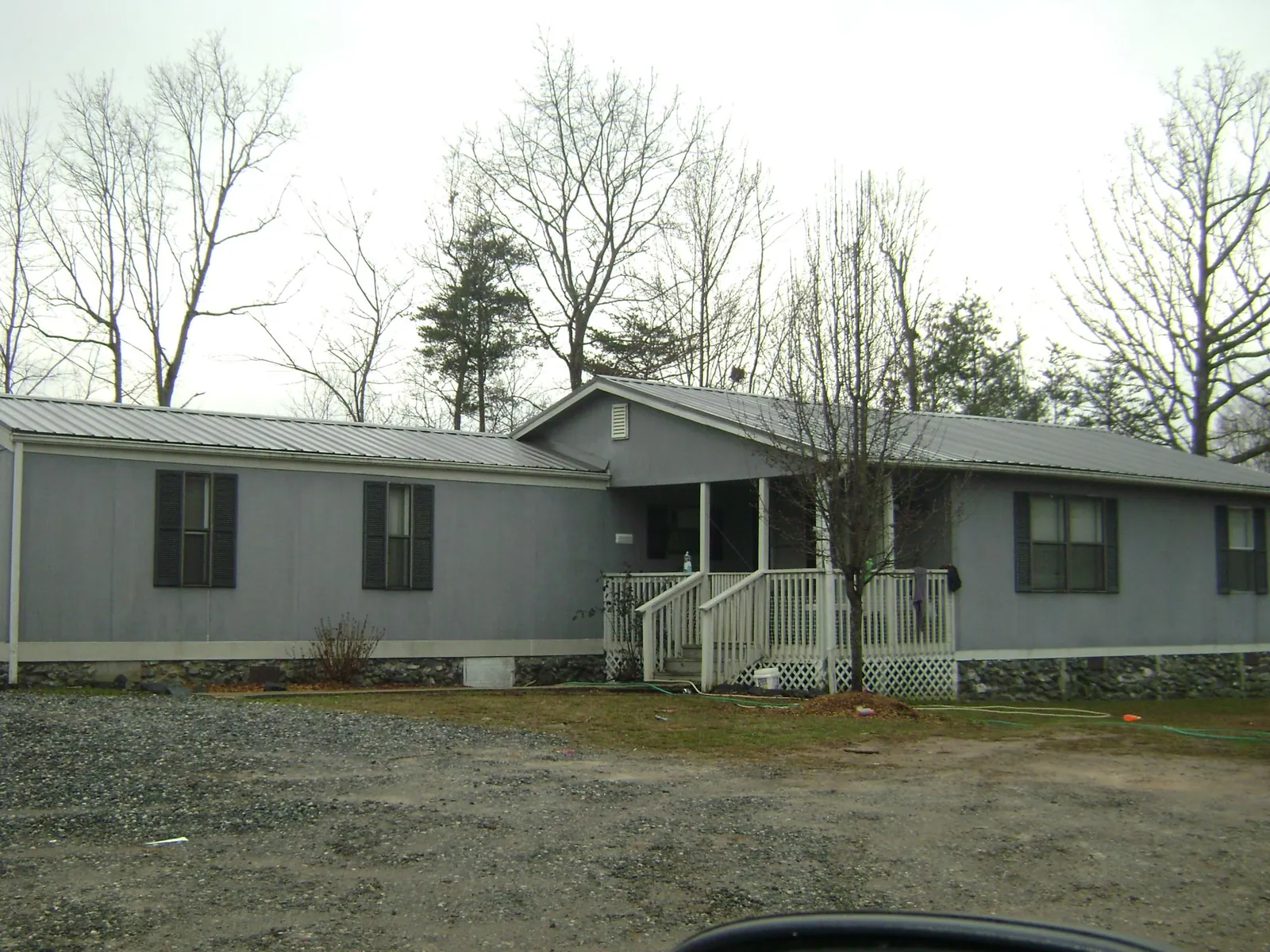 Metal roof over a manufactured home with a covered front porch in Constantia
