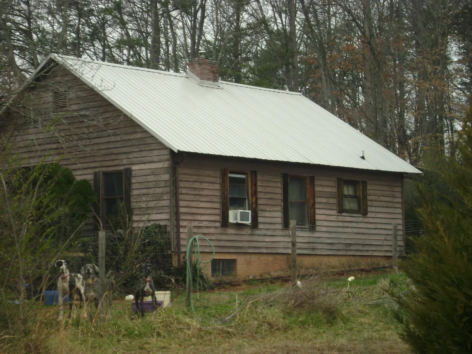 White metal roof on an old wood sided farmhouse, from a Metal Roof Installation job in Constantia